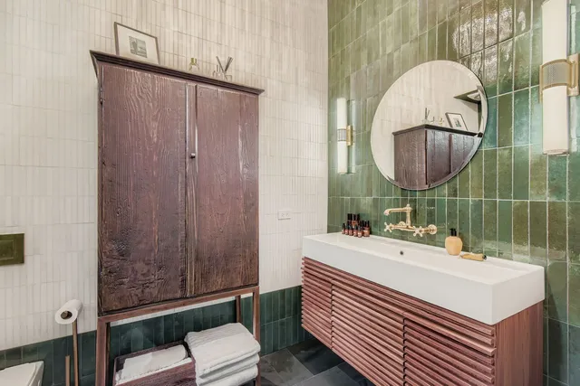 a bathroom with a sink a mirror and a shower