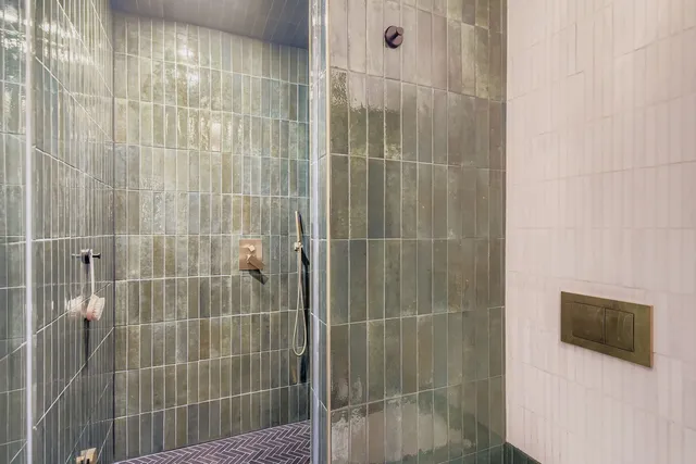 a bathroom with a shower and a mirror