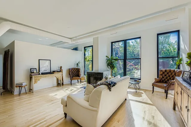 a living room with furniture and large windows