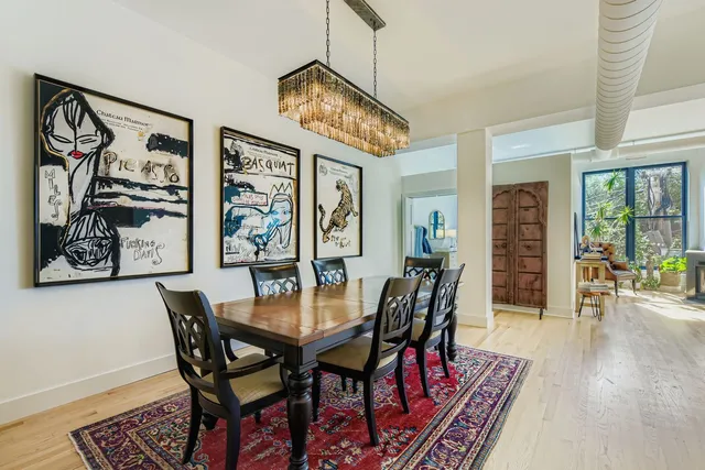 a dining room with furniture and wooden floor