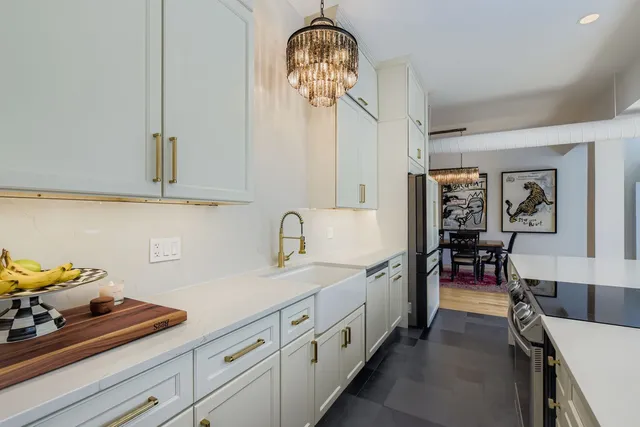 a hallway with sink and cabinets