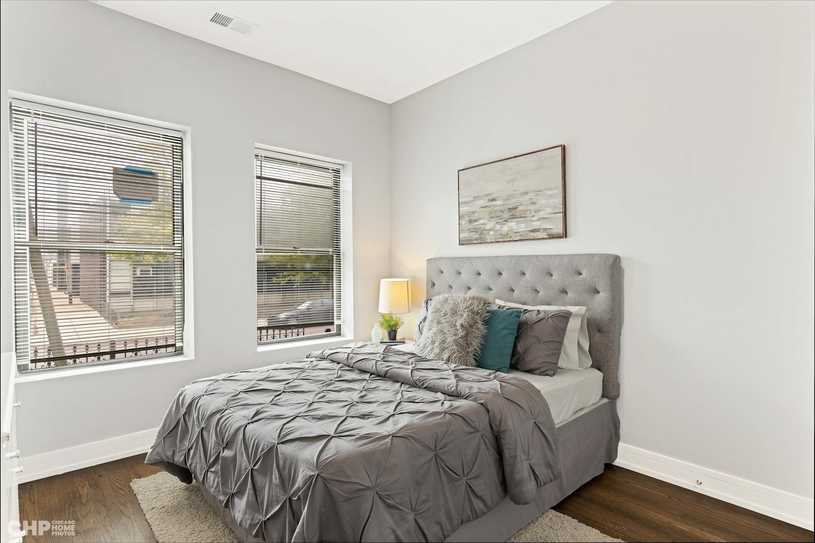 416 East 44th Street, Unit 1 Chicago, IL 60653 - Photo 14 of 25 a bed sitting in a bedroom next to a window