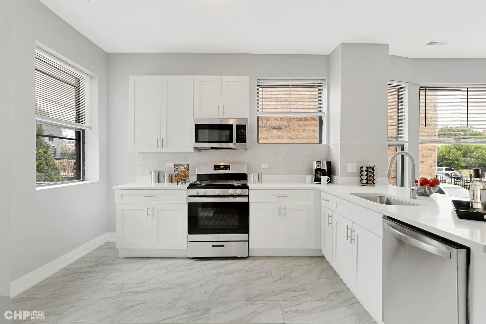 416 East 44th Street, Unit 1 Chicago, IL 60653 - Photo 10 of 25 a kitchen with cabinets appliances a sink and a window