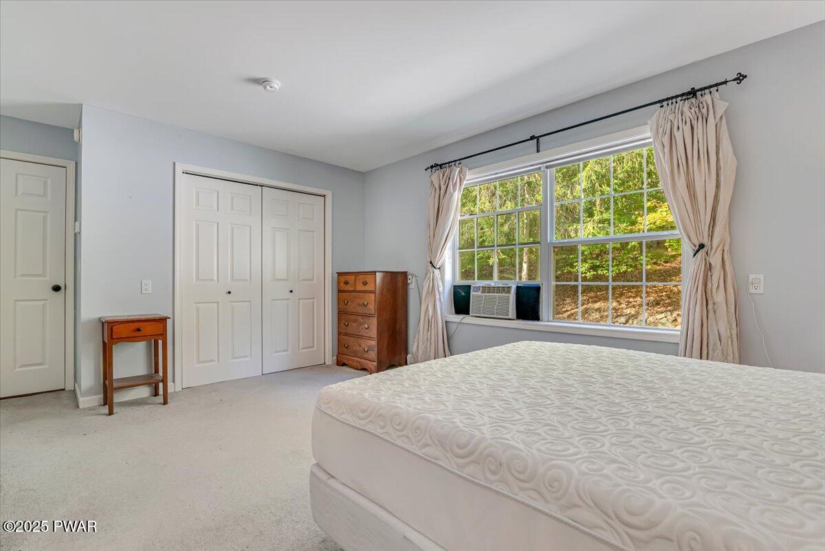 42 Beaver Pond Road Lake Ariel, PA 18436 - Photo 18 of 77 a spacious bedroom with a large bed and a large window