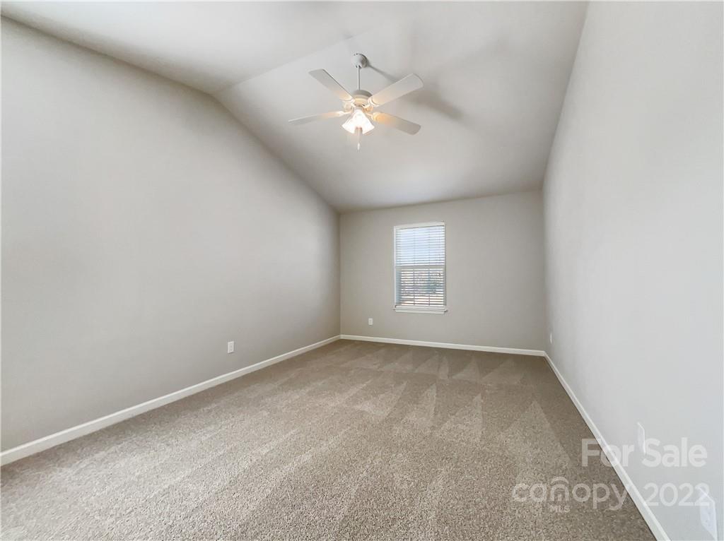 2108 Gunnars Ridge Road Lancaster, SC 29720 - Photo 8 of 18 an empty room with a chandelier fan and windows