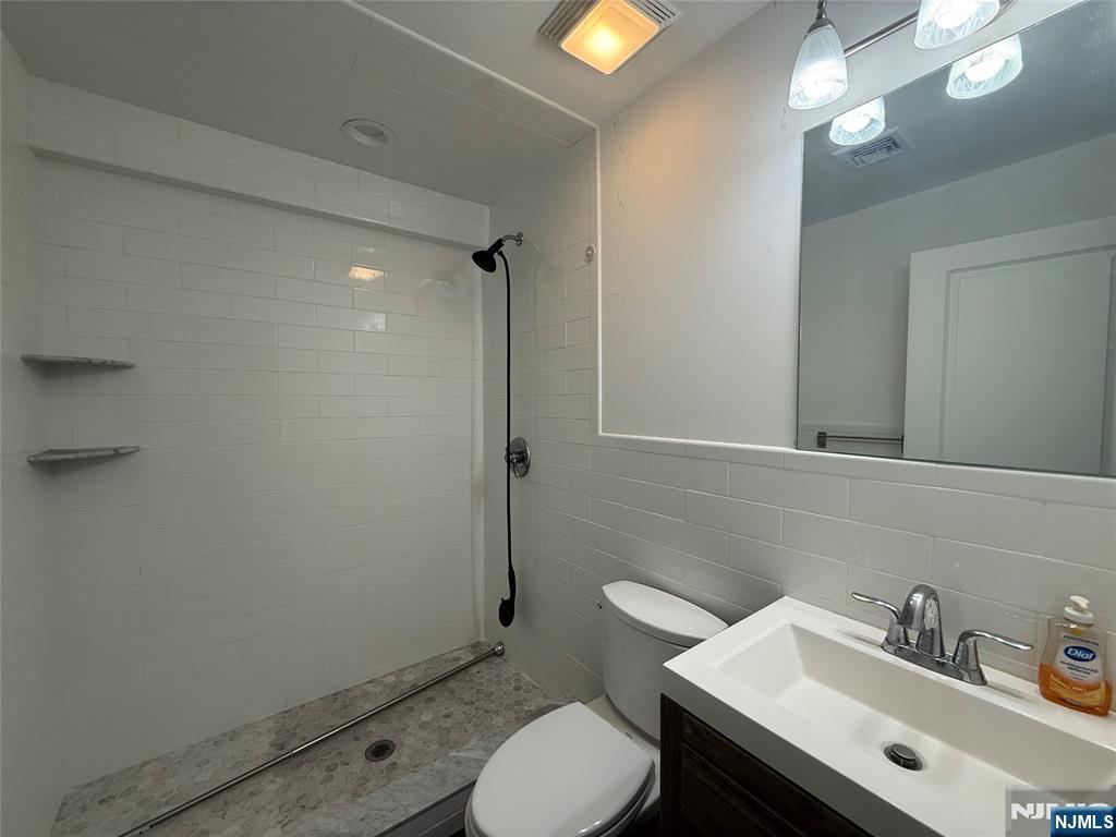 43 Jackson Avenue, Unit 1 Hackensack, NJ 07601 - Photo 12 of 14 a bathroom with a sink toilet and vanity