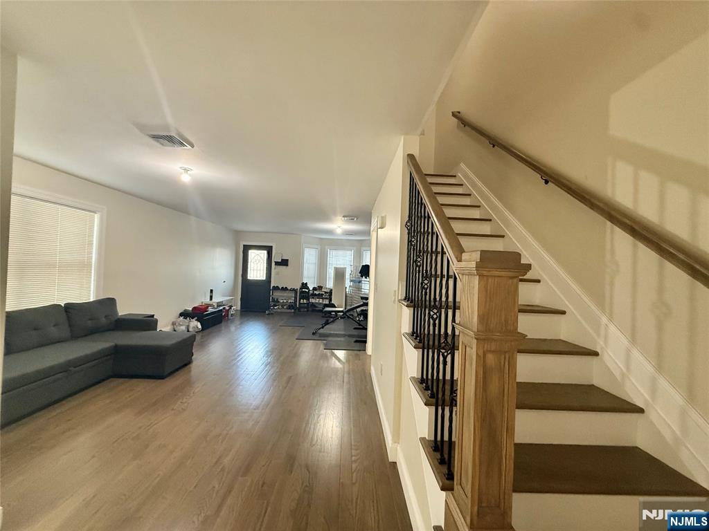 43 Jackson Avenue, Unit 1 Hackensack, NJ 07601 - Photo 3 of 14 a living room with furniture and a wooden floor