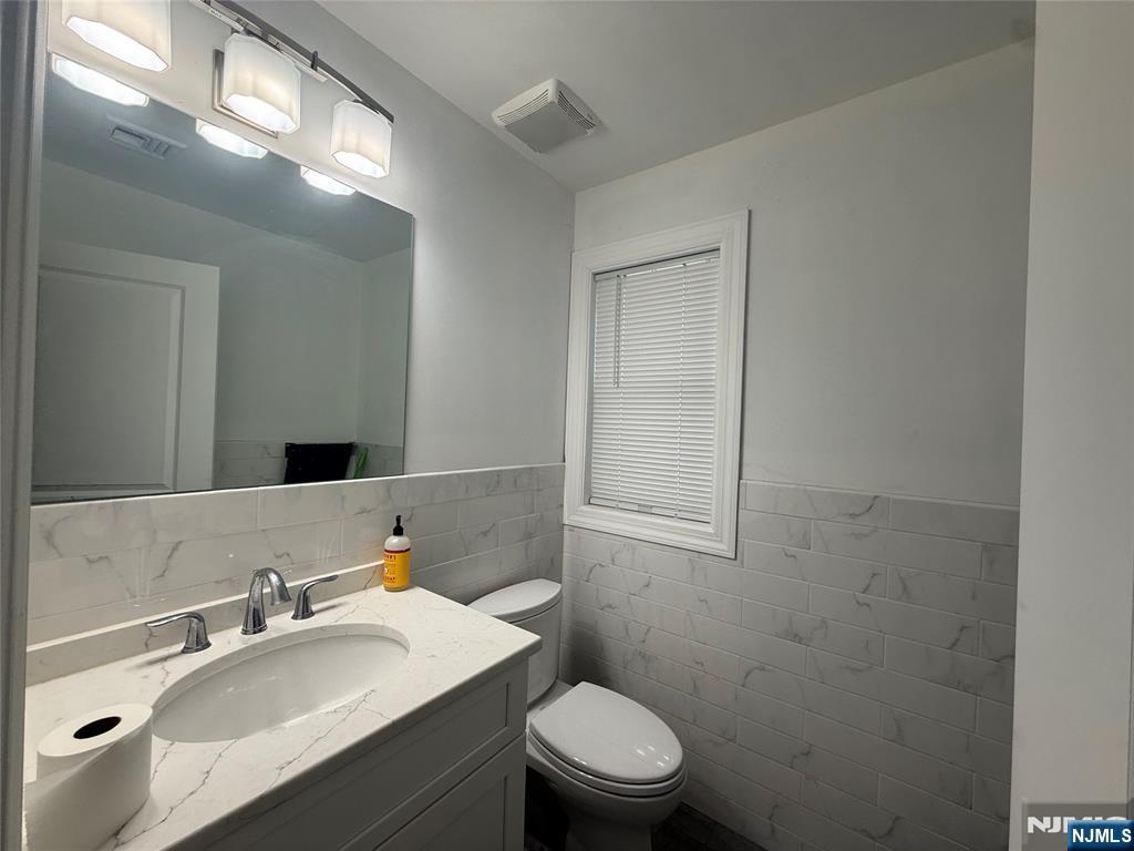 43 Jackson Avenue, Unit 1 Hackensack, NJ 07601 - Photo 5 of 14 a bathroom with a sink toilet and mirror