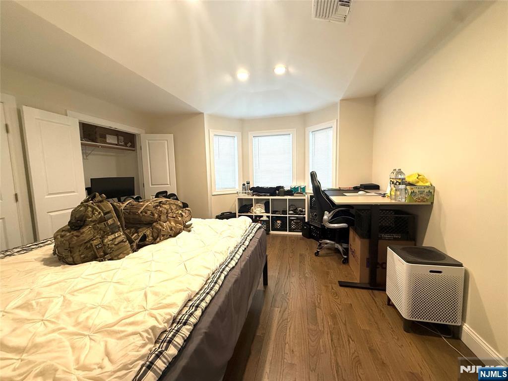 43 Jackson Avenue, Unit 1 Hackensack, NJ 07601 - Photo 9 of 14 a bed room with a bed and furniture