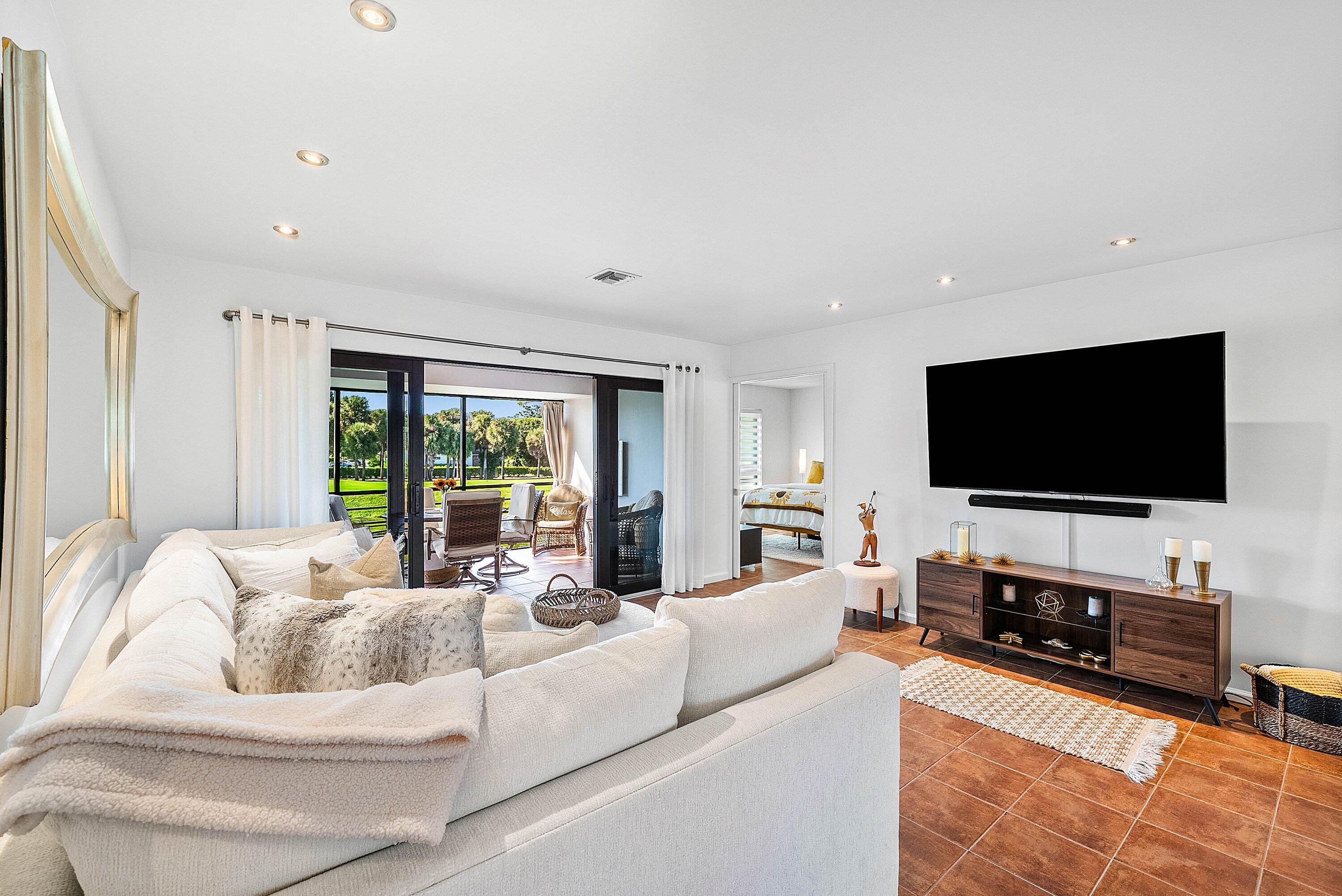 11126 Quail Covey Road, Unit MOCKINGBIRD Boynton Beach, FL 33436 - Photo 13 of 58 a living room with furniture and a flat screen tv