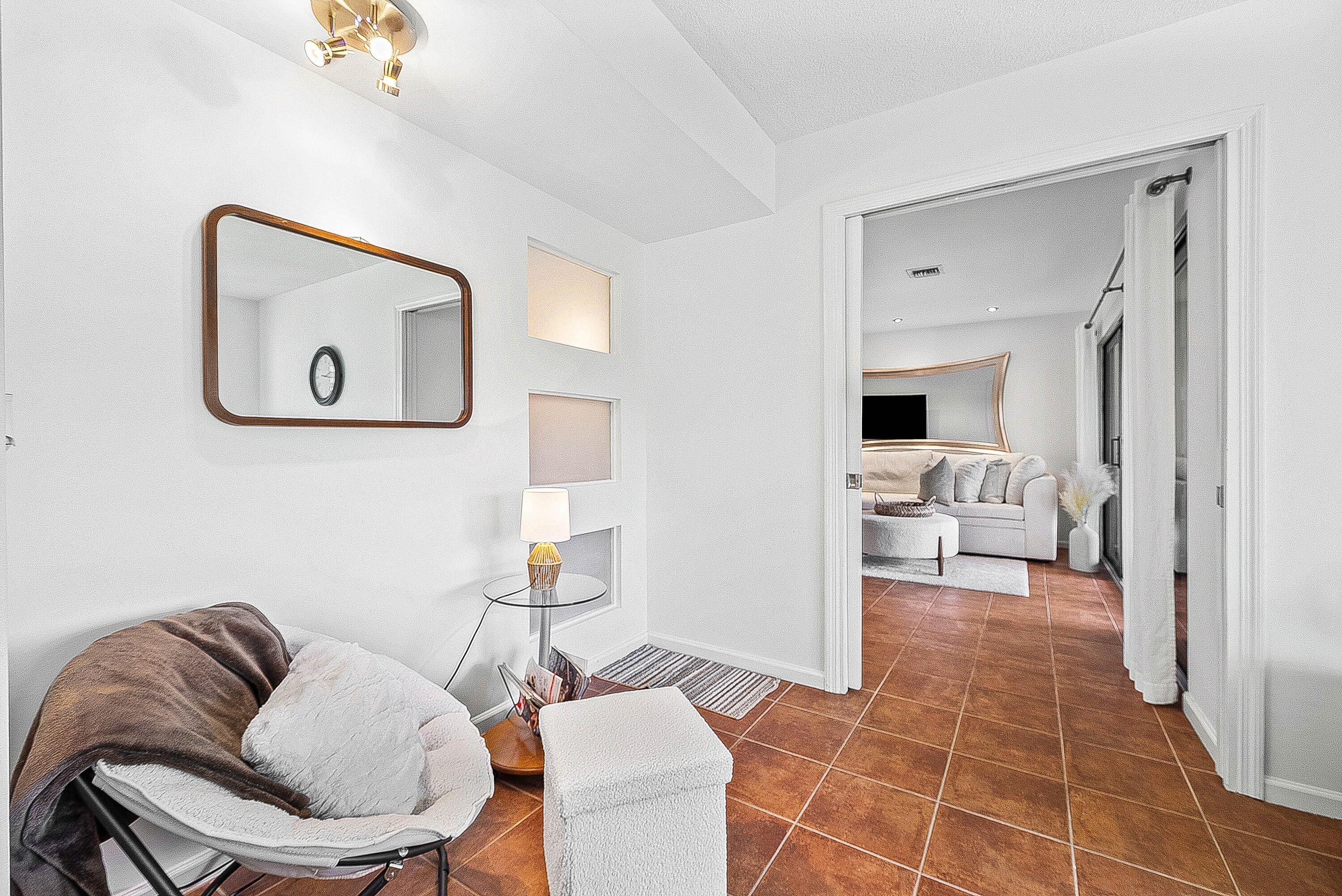 11126 Quail Covey Road, Unit MOCKINGBIRD Boynton Beach, FL 33436 - Photo 18 of 58 a living room with furniture and a painting on the wall