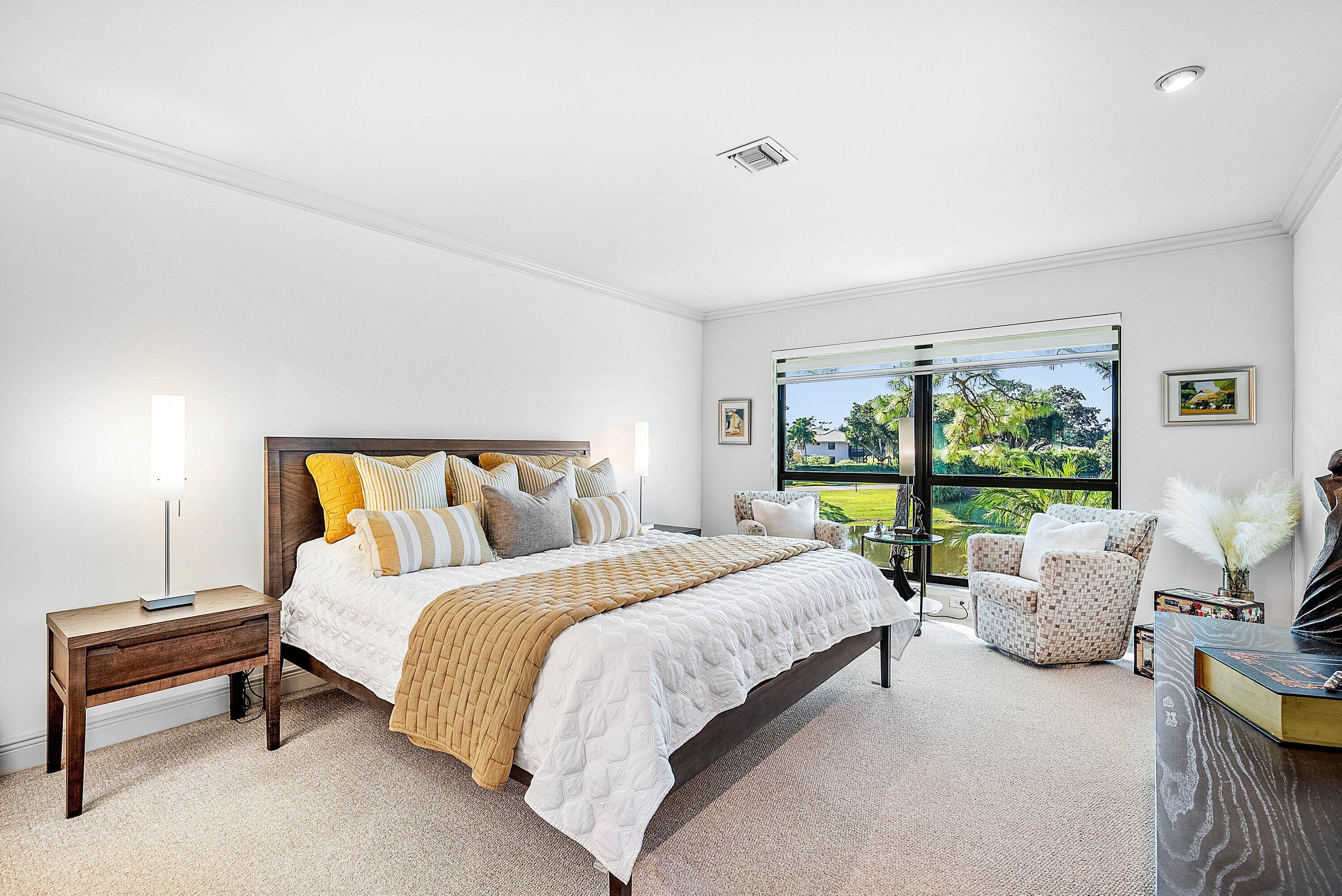 11126 Quail Covey Road, Unit MOCKINGBIRD Boynton Beach, FL 33436 - Photo 22 of 58 a bedroom with a bed and large window