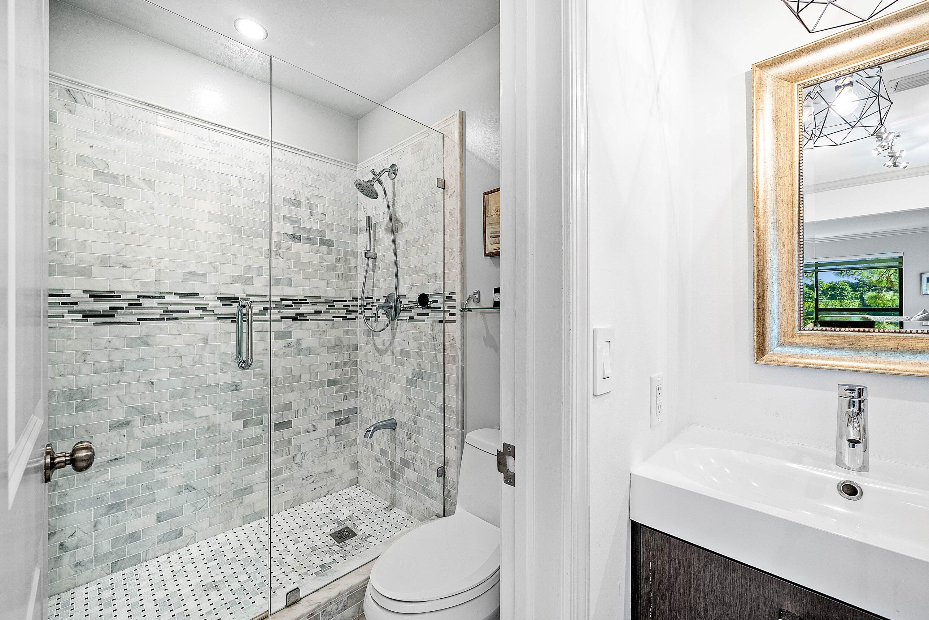 11126 Quail Covey Road, Unit MOCKINGBIRD Boynton Beach, FL 33436 - Photo 27 of 58 a bathroom with a sink a toilet and shower