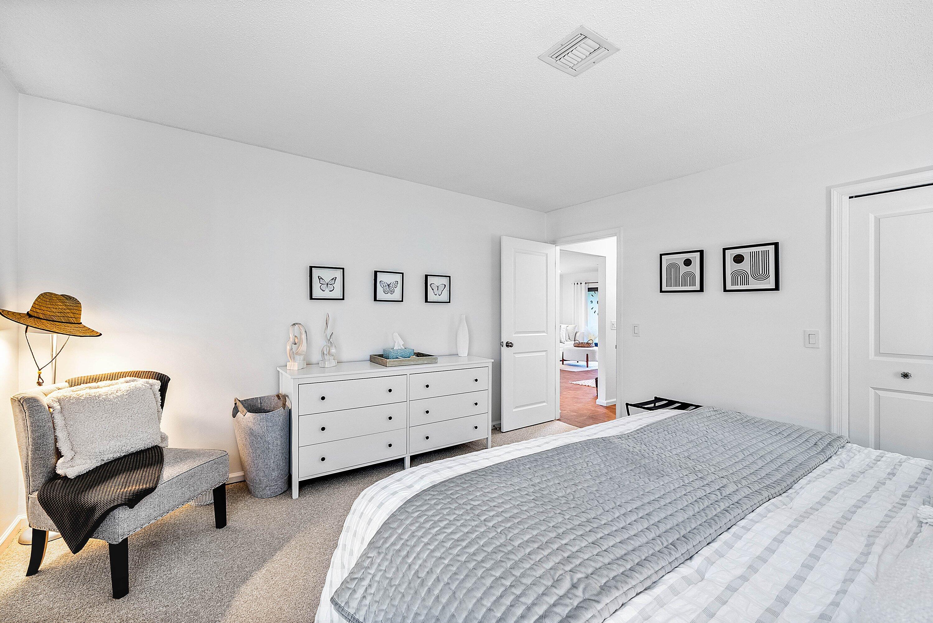 11126 Quail Covey Road, Unit MOCKINGBIRD Boynton Beach, FL 33436 - Photo 29 of 58 a bedroom with a bed and a chair