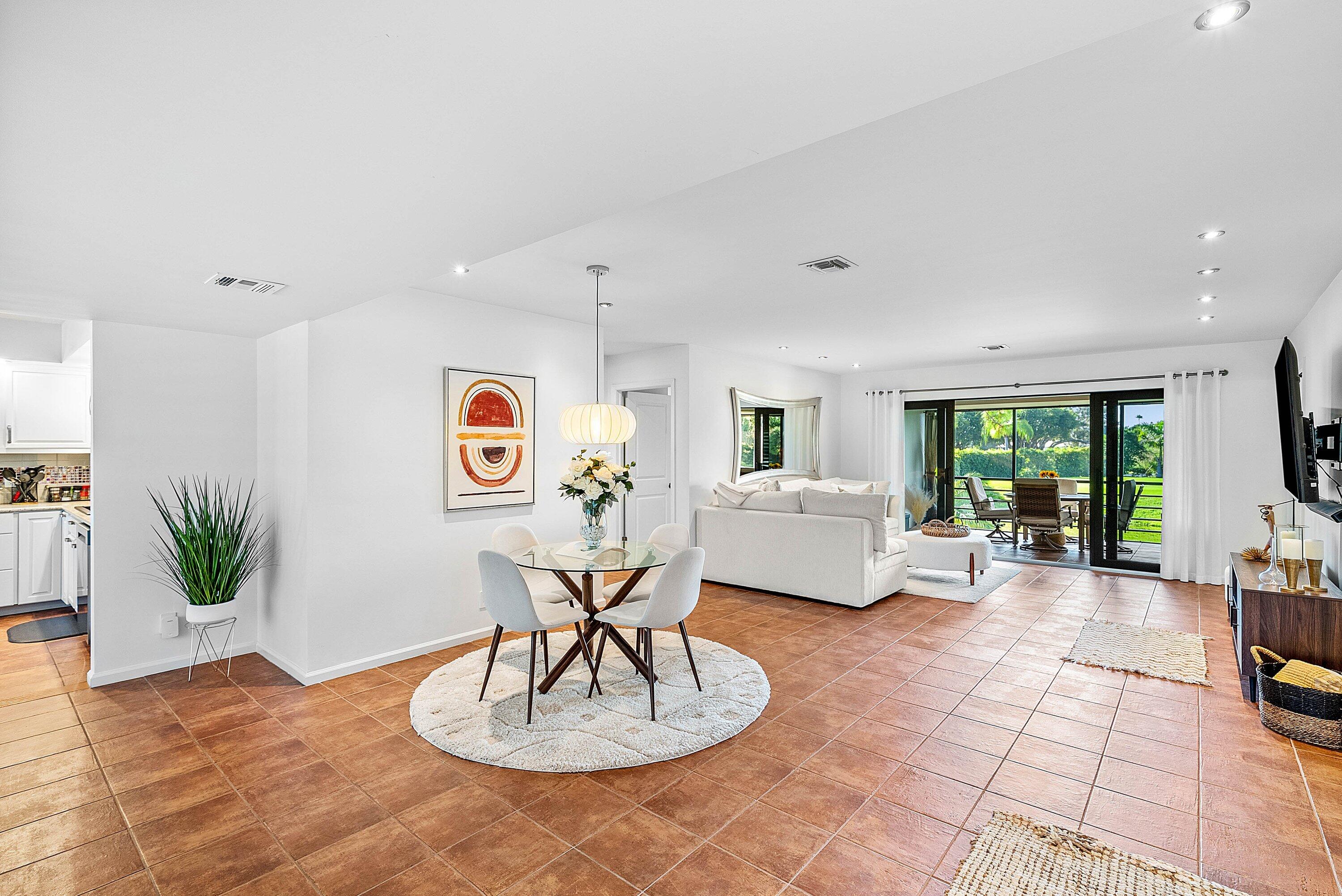 11126 Quail Covey Road, Unit MOCKINGBIRD Boynton Beach, FL 33436 - Photo 4 of 58 a living room with furniture potted plant and a large window