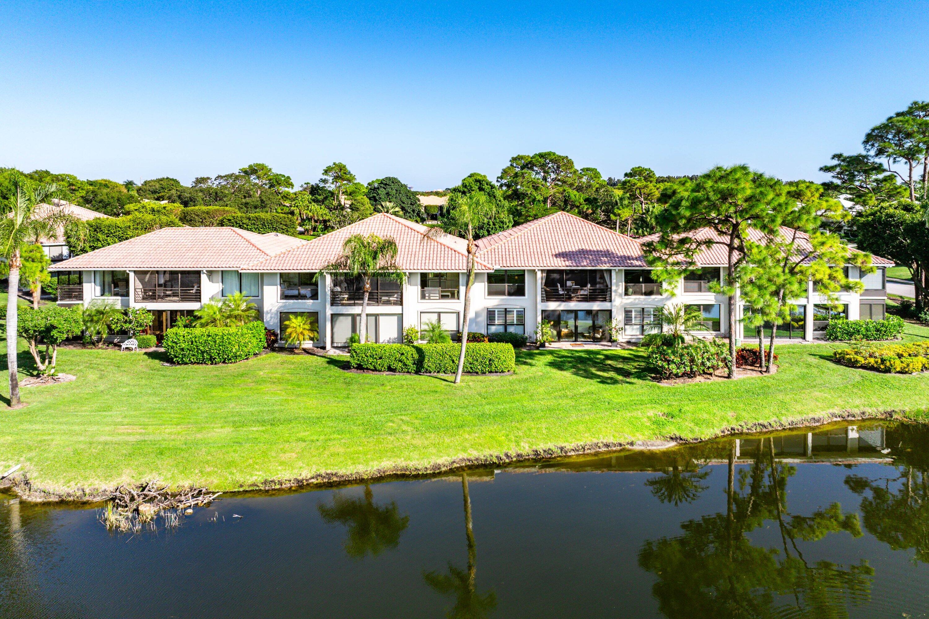 11126 Quail Covey Road, Unit MOCKINGBIRD Boynton Beach, FL 33436 - Photo 44 of 58 a view of a house with a yard and swimming pool