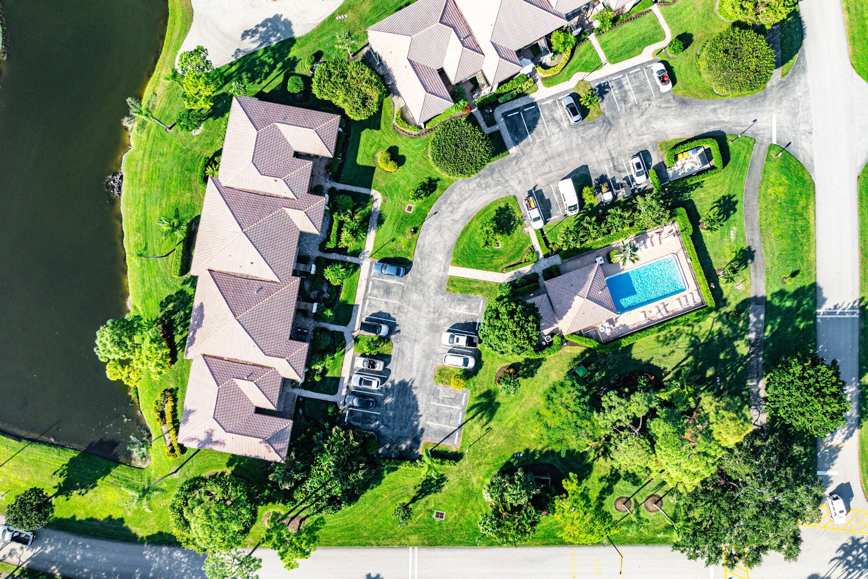 11126 Quail Covey Road, Unit MOCKINGBIRD Boynton Beach, FL 33436 - Photo 45 of 58 an aerial view of a house with a yard and garden