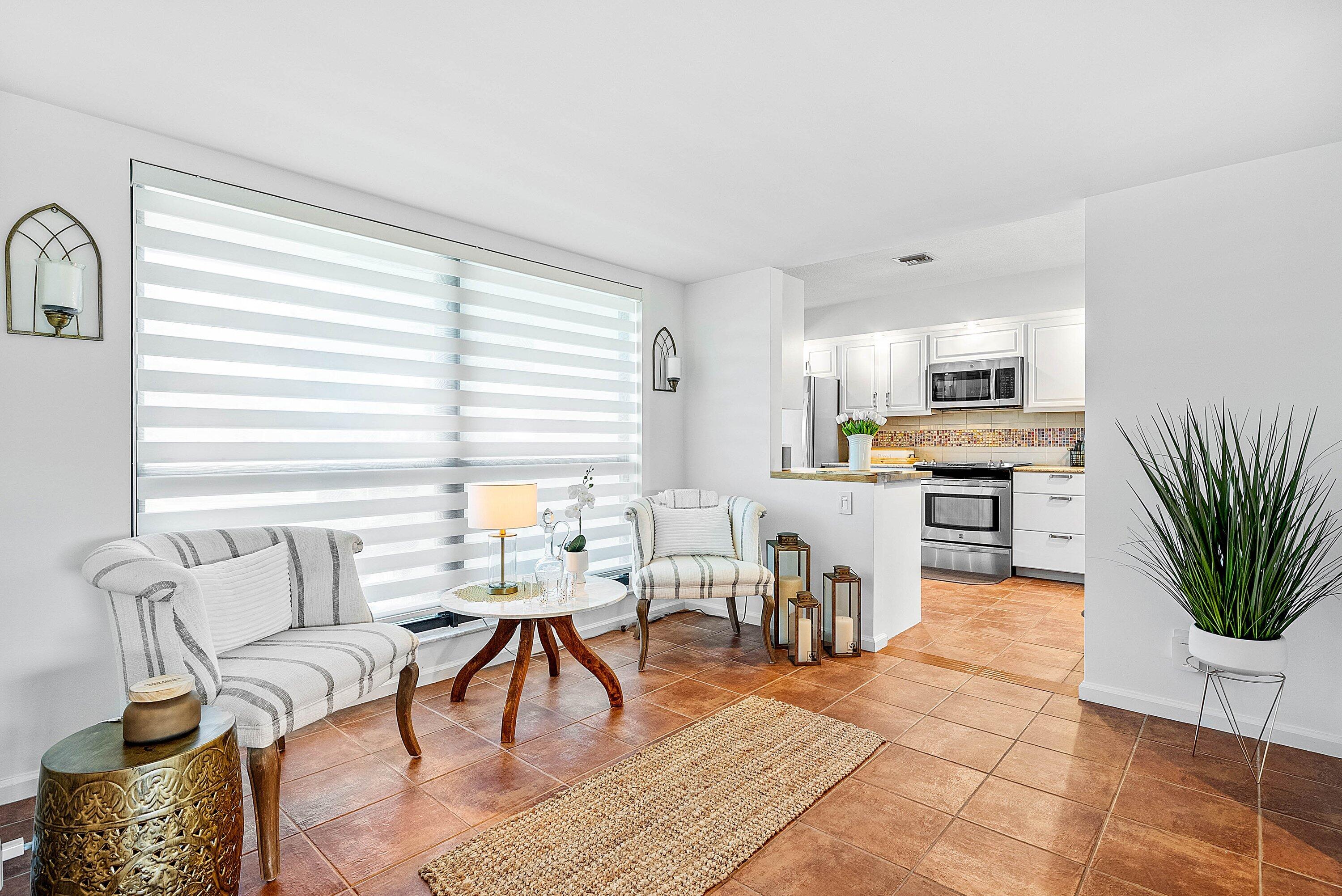 11126 Quail Covey Road, Unit MOCKINGBIRD Boynton Beach, FL 33436 - Photo 8 of 58 a living room with furniture dining table and a fireplace