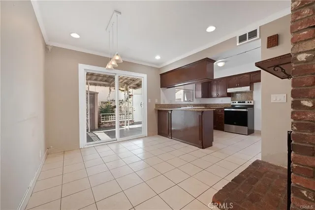 a kitchen with stainless steel appliances granite countertop a refrigerator a sink a stove and oven