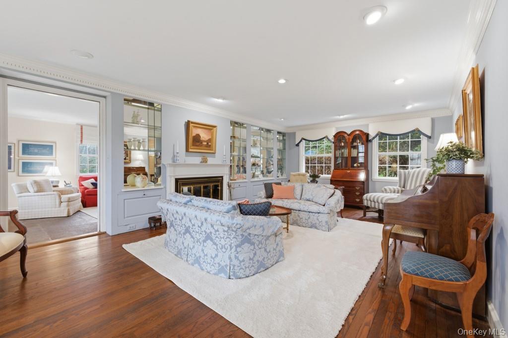 179 River Road Briarcliff Manor, NY 10510 - Photo 5 of 37 Living room featuring ornamental molding, dark wood-type flooring, a glass covered fireplace, and recessed lighting
