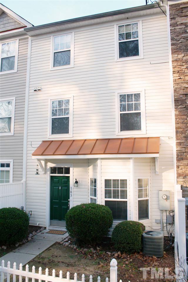 11720 Mezzanine Drive, Unit 103 Raleigh, NC 27614 - Photo 1 of 21 a front view of a brick house with a yard and plants