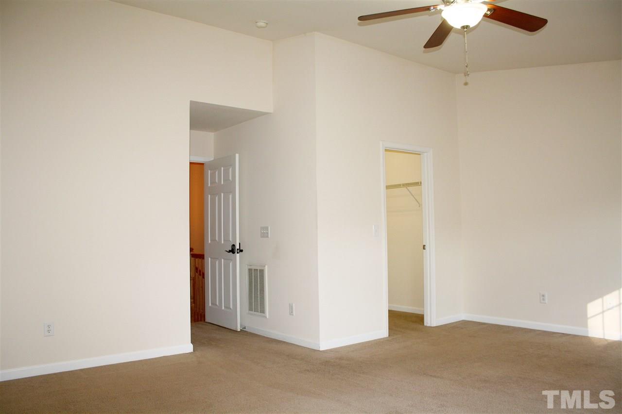 11720 Mezzanine Drive, Unit 103 Raleigh, NC 27614 - Photo 12 of 21 an empty room with a ceiling fan and a window