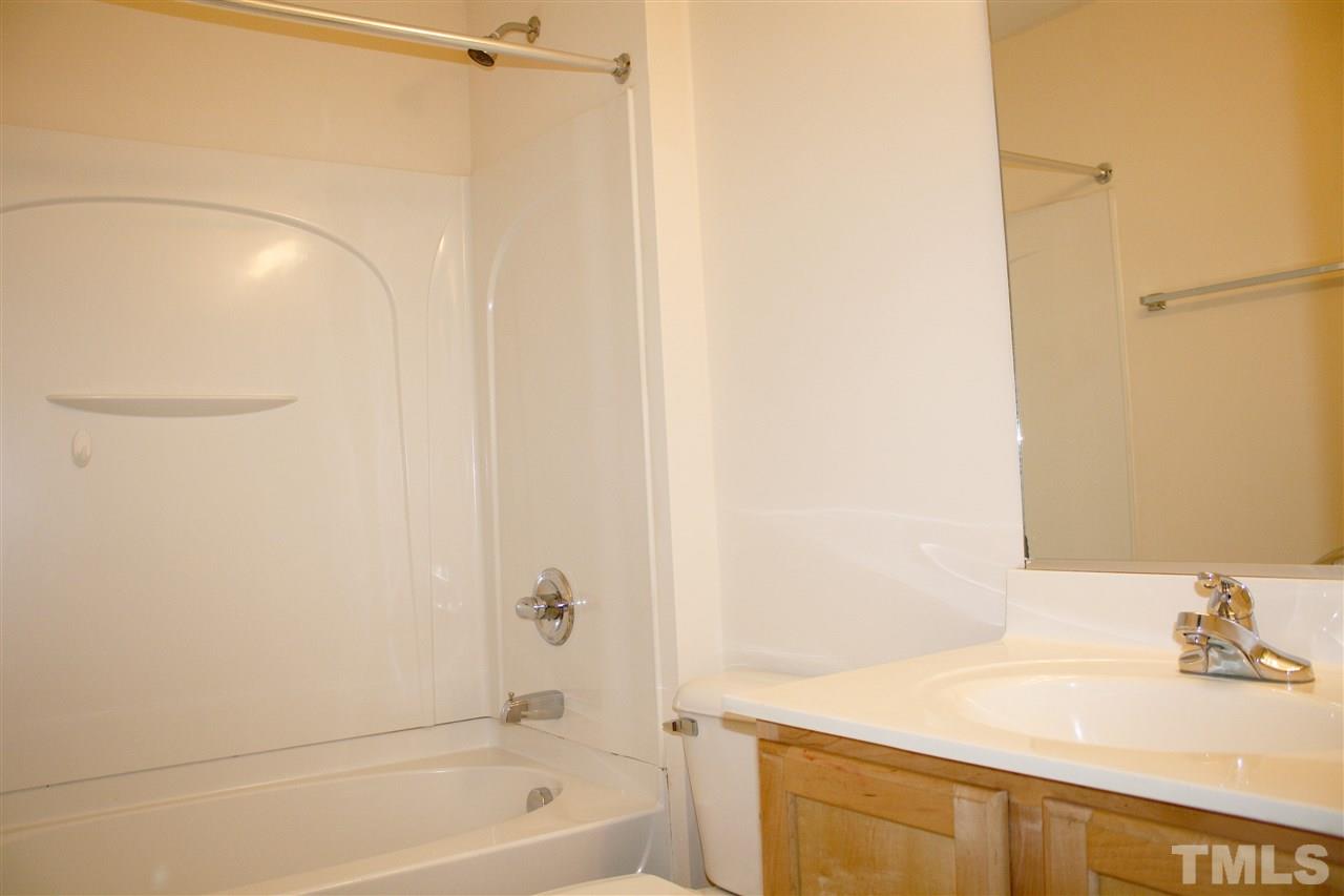 11720 Mezzanine Drive, Unit 103 Raleigh, NC 27614 - Photo 19 of 21 a bathroom with a bathtub and a sink