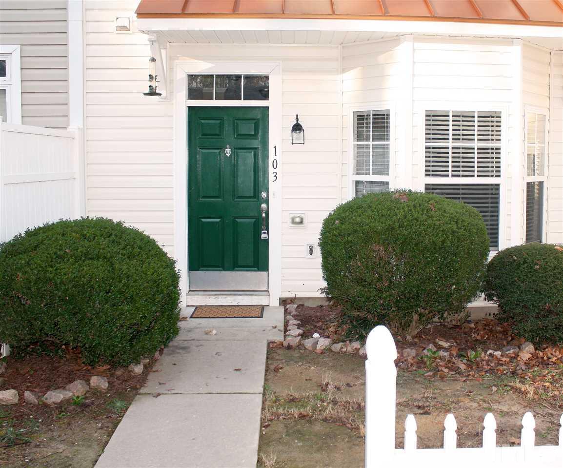11720 Mezzanine Drive, Unit 103 Raleigh, NC 27614 - Photo 3 of 21 a front view of a house with a garden