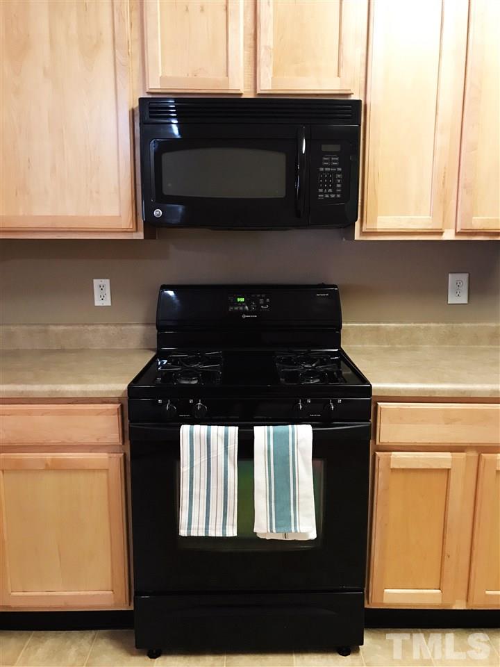 11720 Mezzanine Drive, Unit 103 Raleigh, NC 27614 - Photo 10 of 21 a kitchen with a stove and a microwave