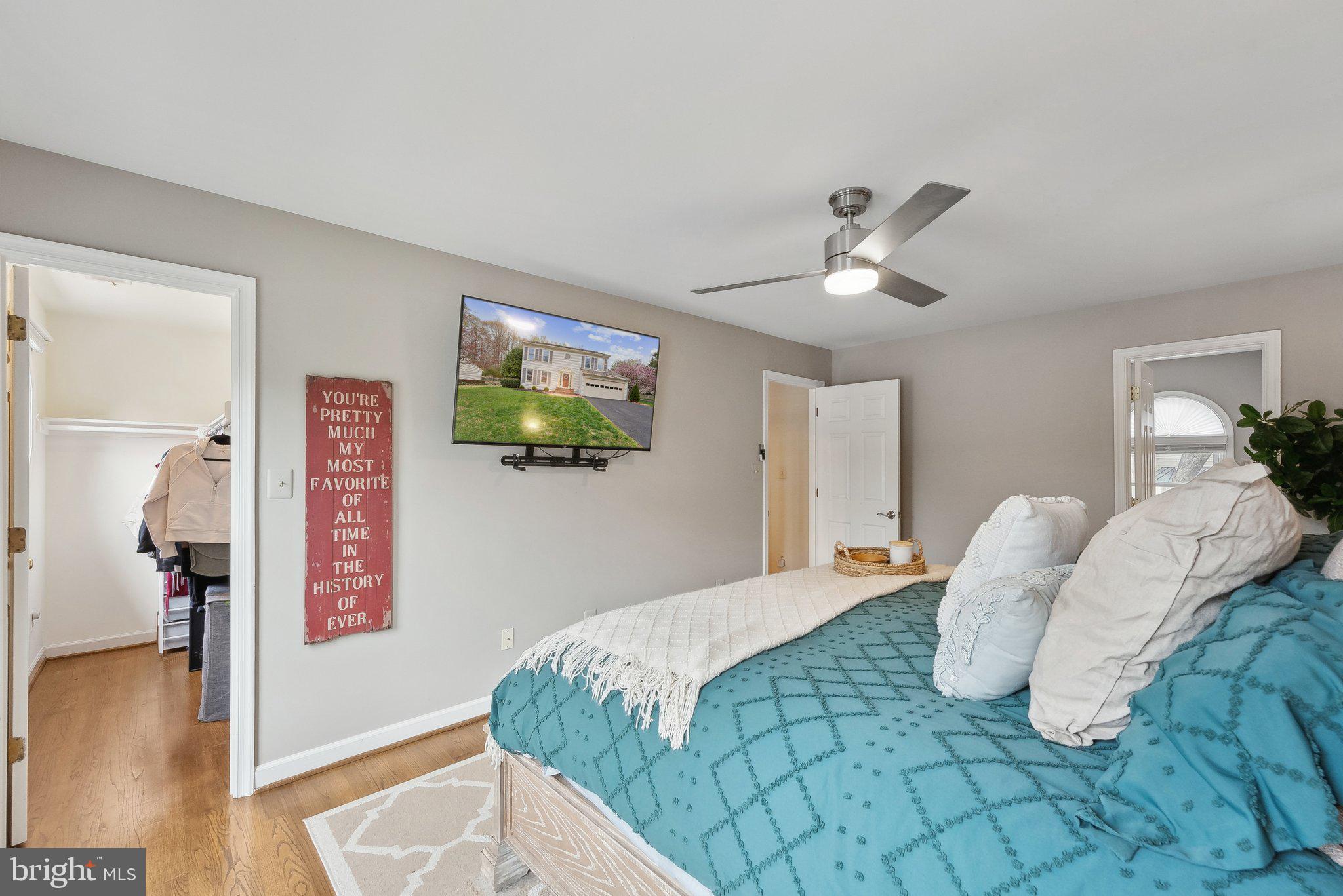 7940 Donegal Lane Springfield, VA 22153 - Photo 17 of 36 a bedroom with a bed and a chandelier
