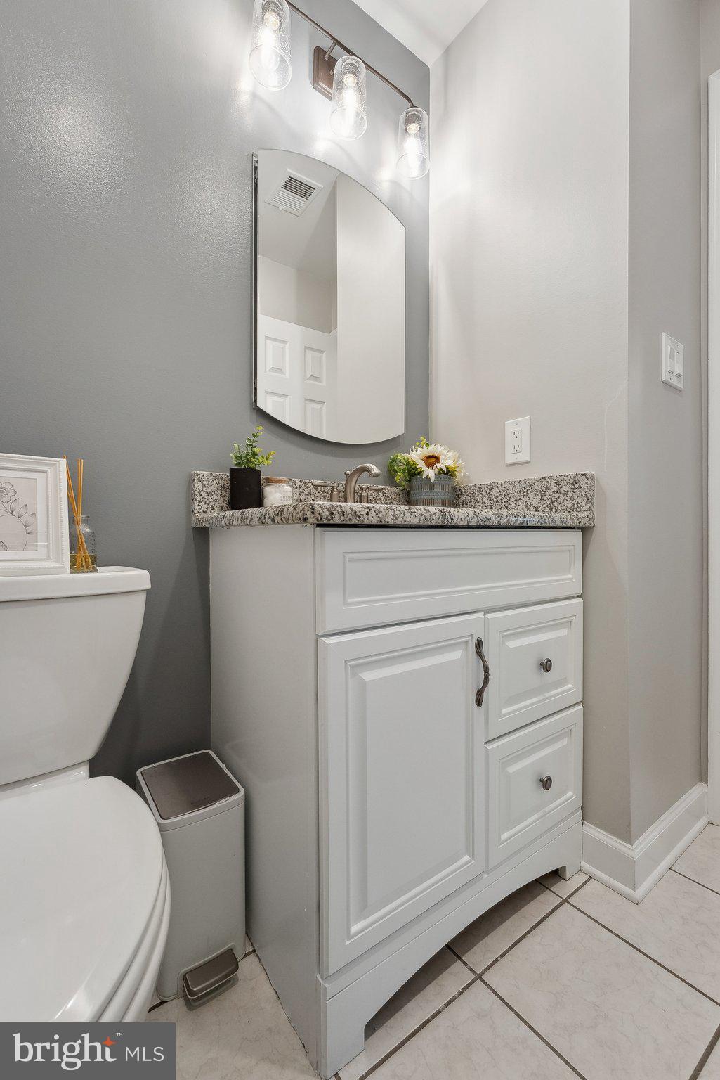 7940 Donegal Lane Springfield, VA 22153 - Photo 27 of 36 a bathroom with a granite countertop toilet sink and a mirror