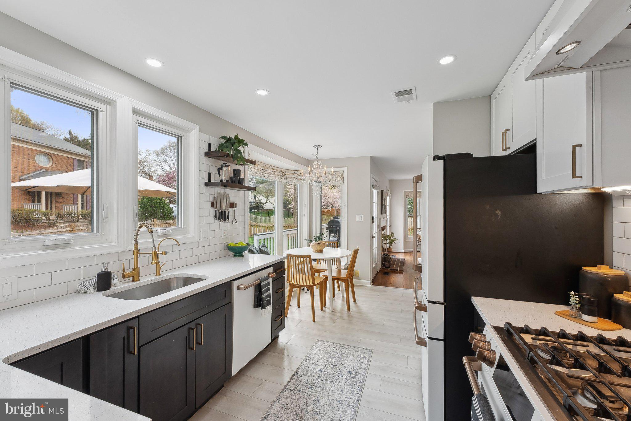 7940 Donegal Lane Springfield, VA 22153 - Photo 9 of 36 a kitchen with a table chairs refrigerator and cabinets