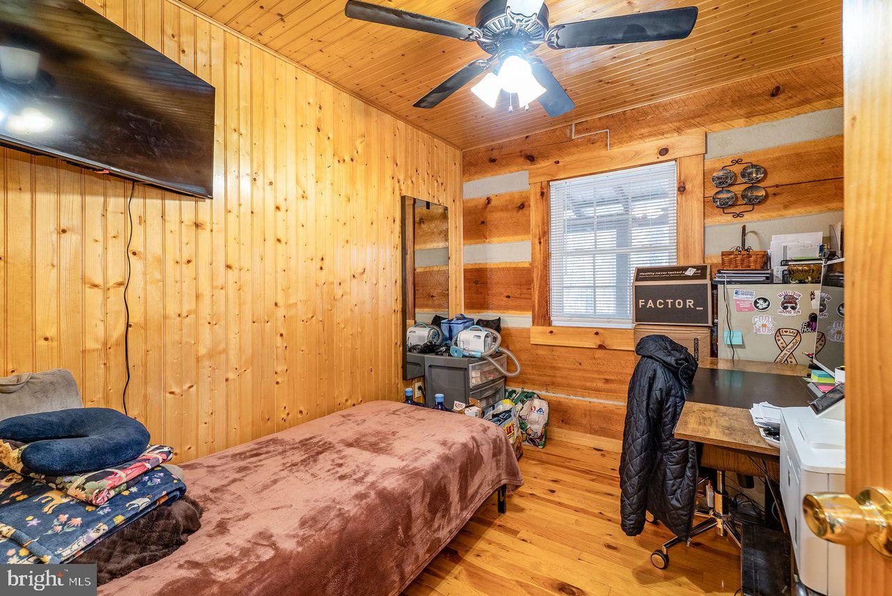 147 Bear Rdg Lane Milam, WV 26838 - Photo 27 of 72 a bedroom with a bed and a chandelier