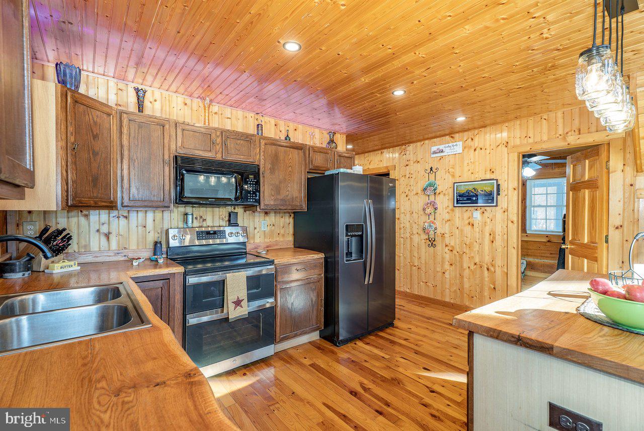 147 Bear Rdg Lane Milam, WV 26838 - Photo 6 of 72 a kitchen with stainless steel appliances granite countertop a sink stove and refrigerator
