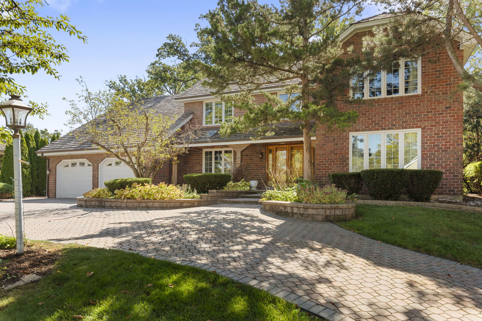 a front view of a house with a yard and potted plants