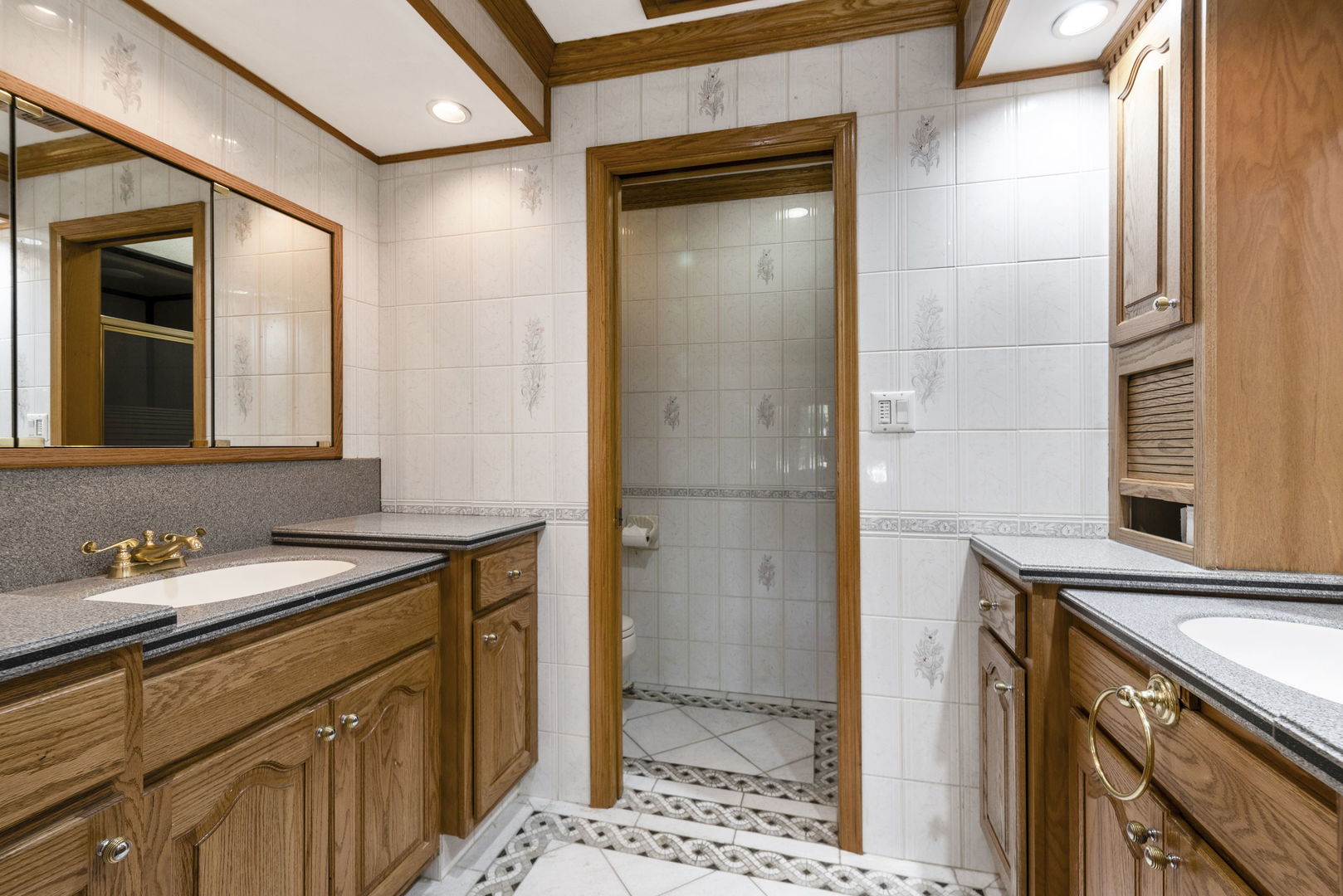 28 Cambridge Drive Oak Brook, IL 60523 - Photo 16 of 28 a bathroom with a sink and a mirror