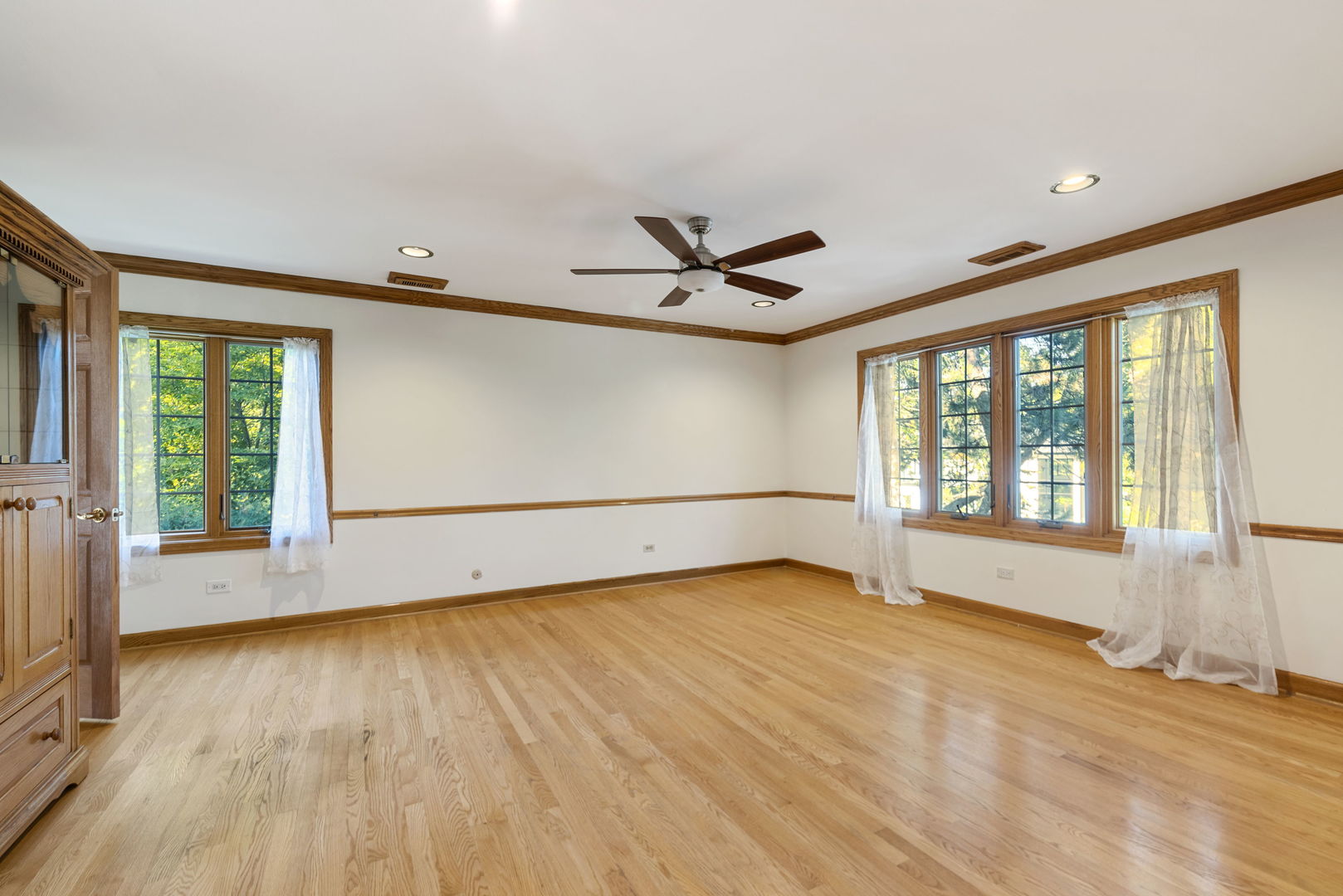 28 Cambridge Drive Oak Brook, IL 60523 - Photo 20 of 28 a view of an empty room with a window and wooden floor