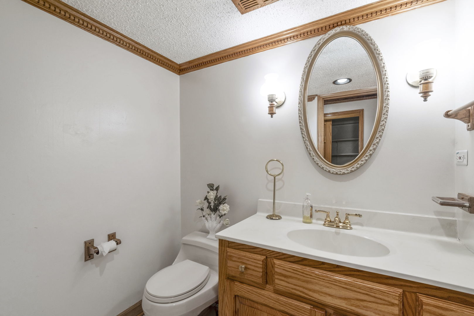 28 Cambridge Drive Oak Brook, IL 60523 - Photo 25 of 28 a bathroom with a toilet a sink a mirror and bathtub