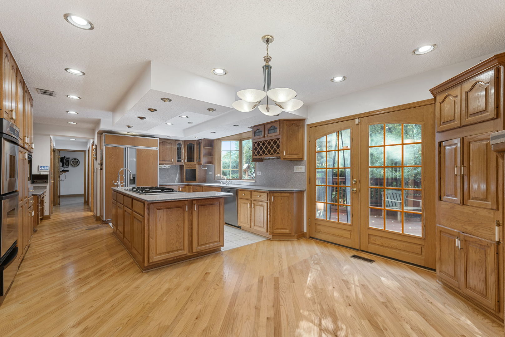 28 Cambridge Drive Oak Brook, IL 60523 - Photo 8 of 28 a large kitchen with a large counter top a sink stainless steel appliances and cabinets