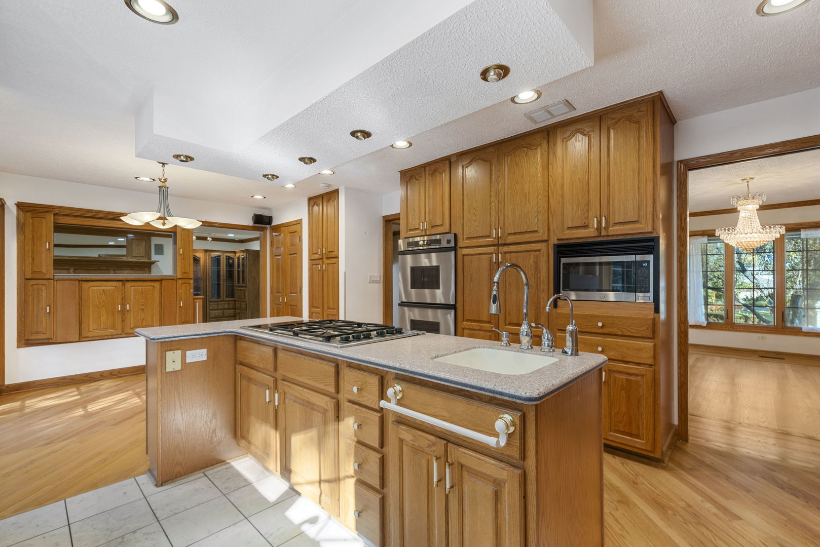28 Cambridge Drive Oak Brook, IL 60523 - Photo 9 of 28 a kitchen with a sink refrigerator and wooden cabinets