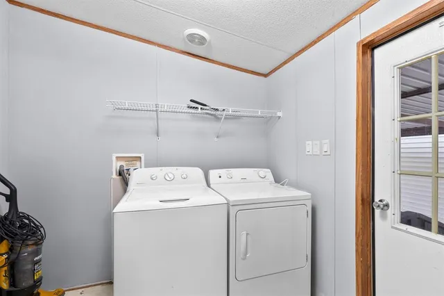 a view of a house with a backyard and a tree