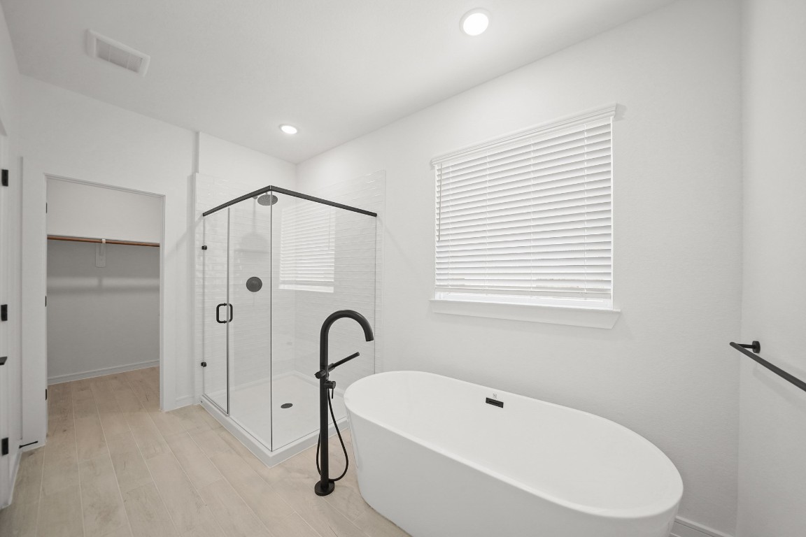 2826 Clapbread Lane Rosenberg, TX 77471 - Photo 13 of 41 a bathroom with a bathtub and a shower