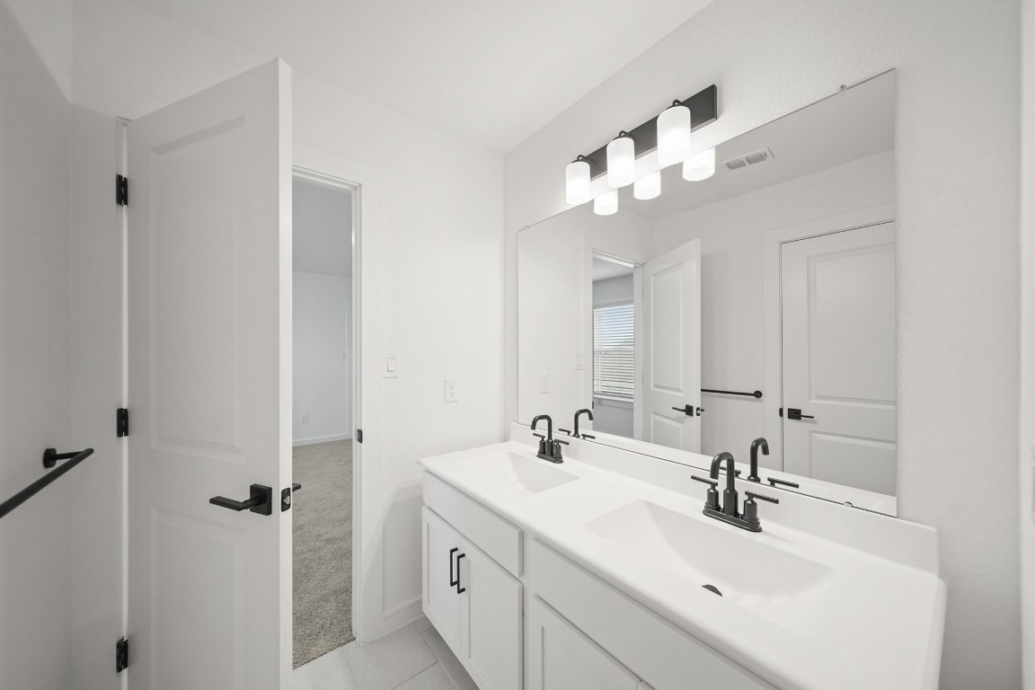 2826 Clapbread Lane Rosenberg, TX 77471 - Photo 16 of 41 a bathroom with a sink vanity and a mirror