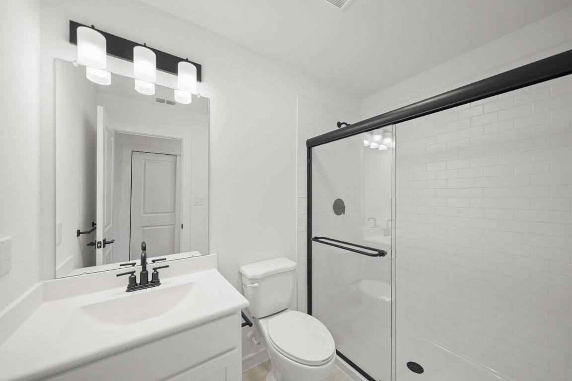 2826 Clapbread Lane Rosenberg, TX 77471 - Photo 19 of 41 a bathroom with a sink vanity mirror and toilet