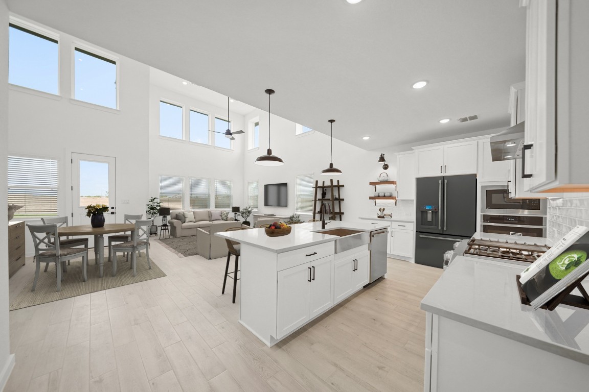2826 Clapbread Lane Rosenberg, TX 77471 - Photo 6 of 41 a kitchen that has a lot of cabinets a sink and a stove in it