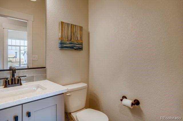 324 Spring Beauty Drive Berthoud, CO 80513 - Photo 11 of 25 a bathroom with a granite countertop sink mirror vanity and toilet