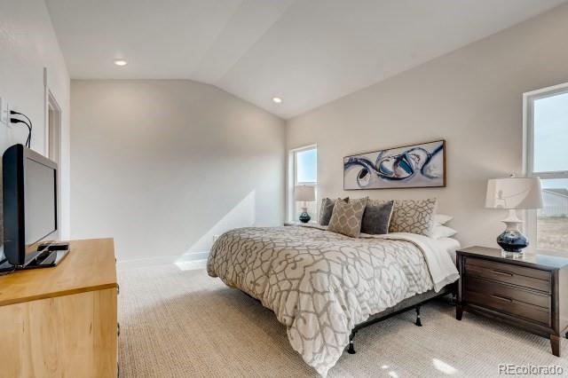 324 Spring Beauty Drive Berthoud, CO 80513 - Photo 12 of 25 a bedroom with a bed and a flat screen tv