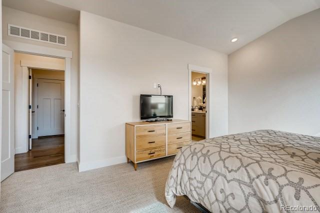 324 Spring Beauty Drive Berthoud, CO 80513 - Photo 13 of 25 a bedroom with a bed and a dresser