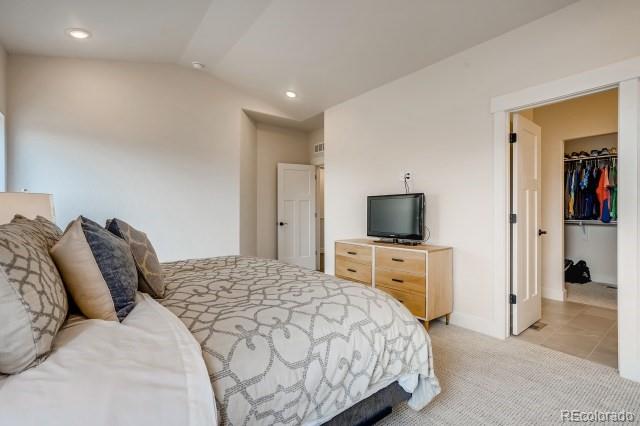 324 Spring Beauty Drive Berthoud, CO 80513 - Photo 14 of 25 a bedroom with a bed and a flat screen tv