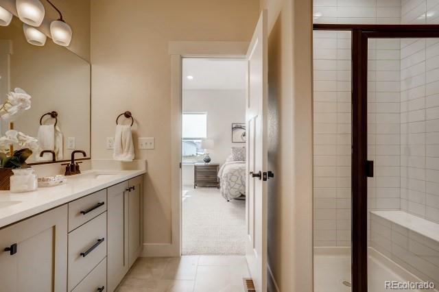 324 Spring Beauty Drive Berthoud, CO 80513 - Photo 17 of 25 a en suite bathroom with a shower sink and mirror